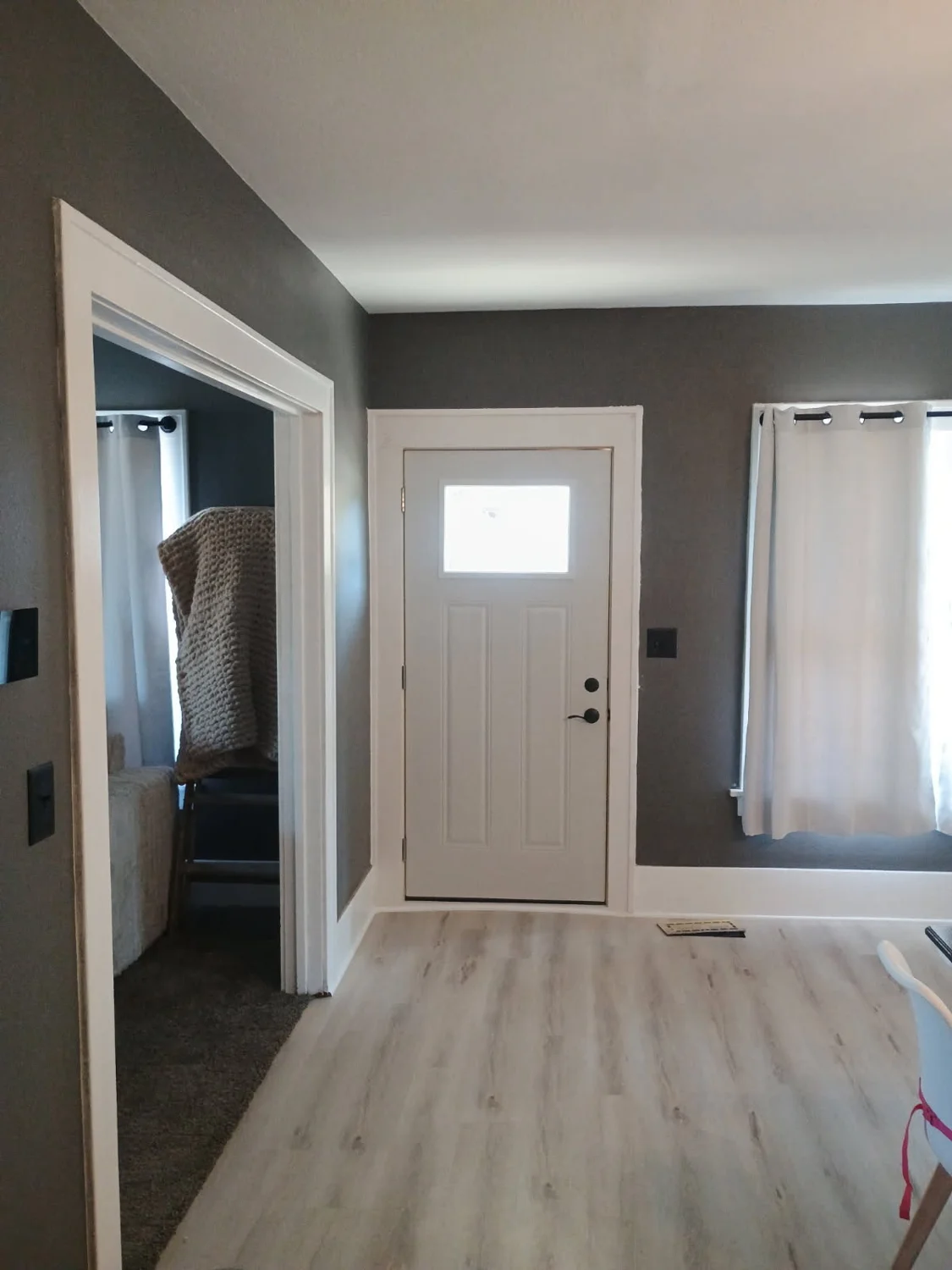 New entry door, white trim, and flooring installed by Terry