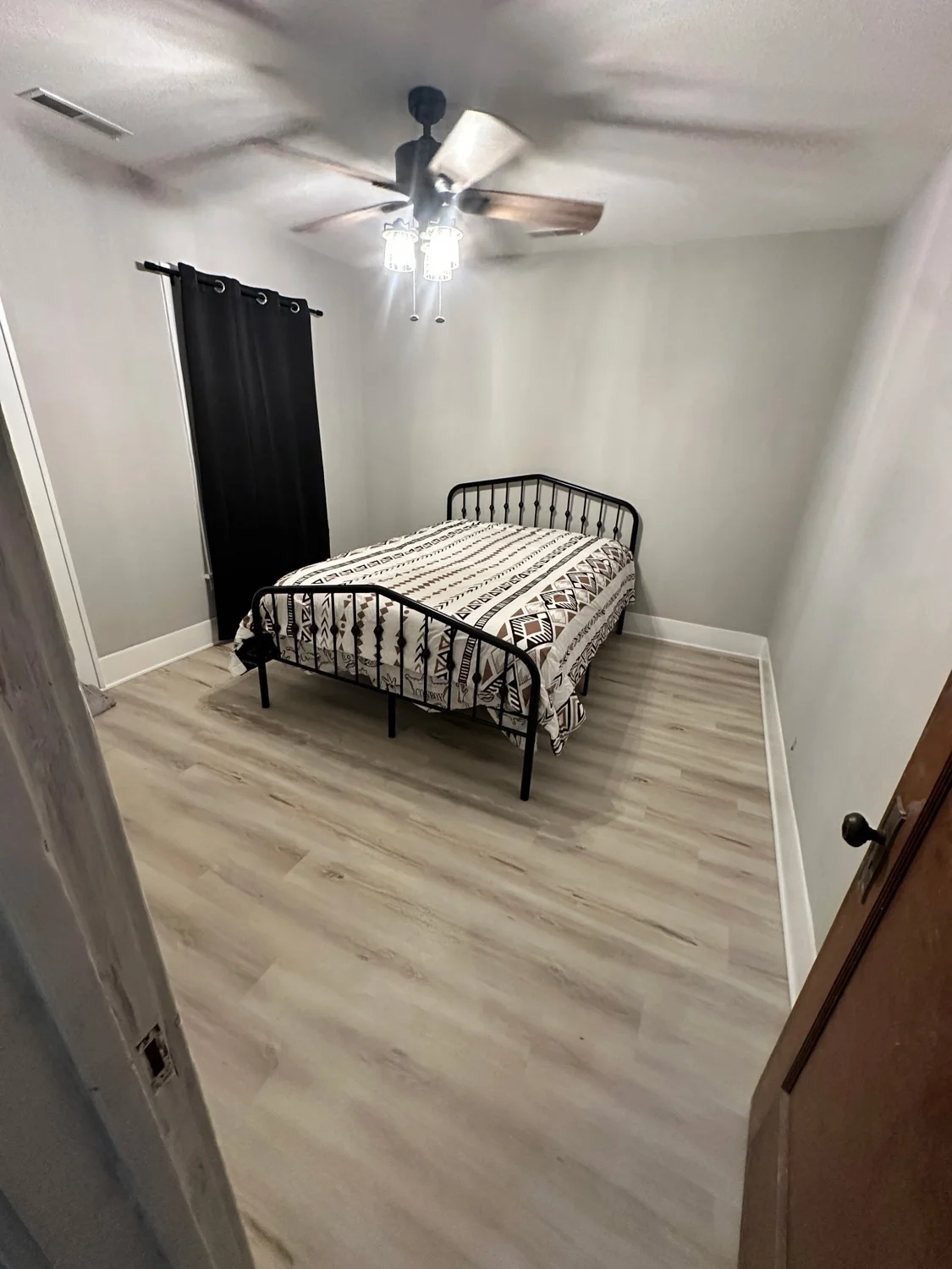 Bedroom with flooring and white base trim installed by Terry